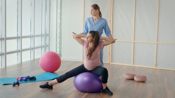 A,Young,Pregnant,Woman,Is,Doing,Exercises,With,A,Health