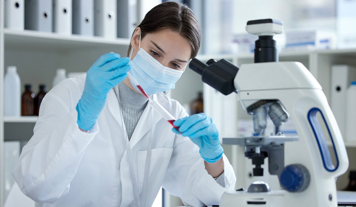 Técnica de análises clínicas analisando resultado de exame de sangue